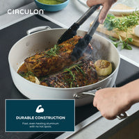 Two pork tenderloins sear in a Ceramic Nonstick 5-Quart Sauté Pan on induction.