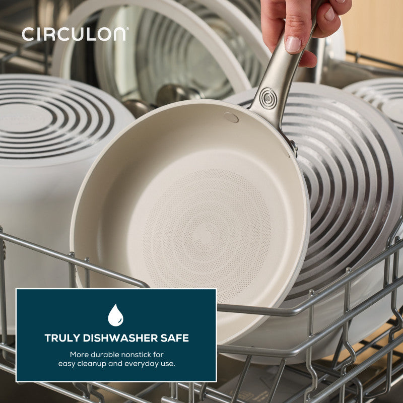 A Ceramic Nonstick 5-Quart Sauté Pan sits in a dishwasher rack with dishes.