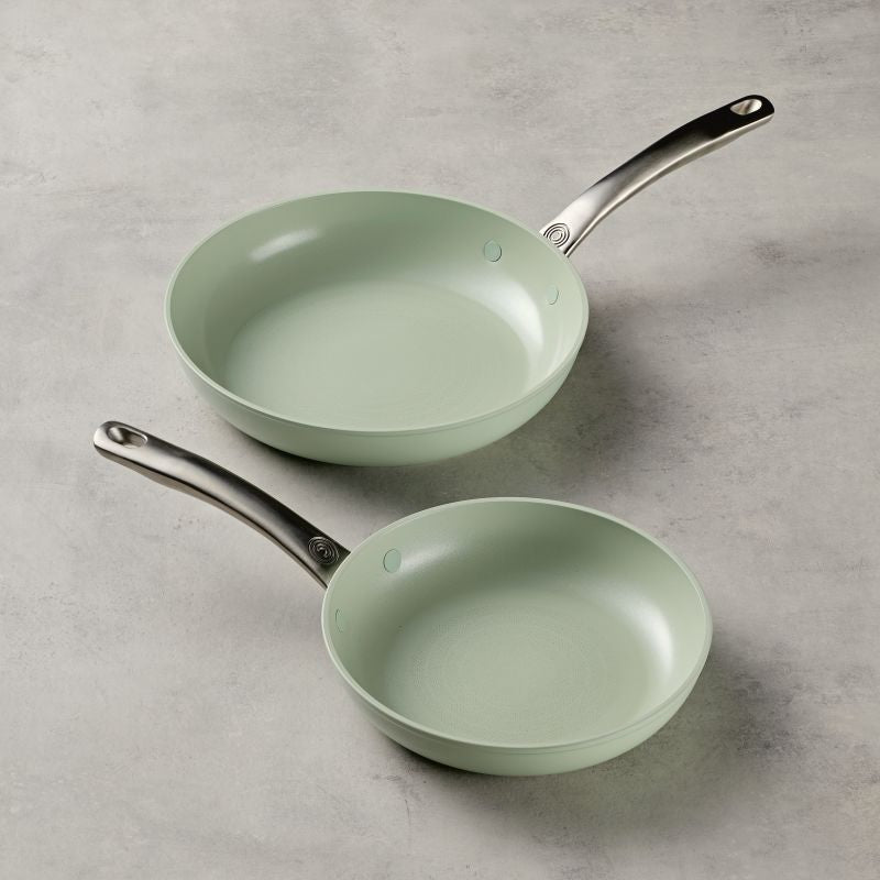 Ceramic Nonstick 2-Piece Skillet Set in light green on a gray surface.