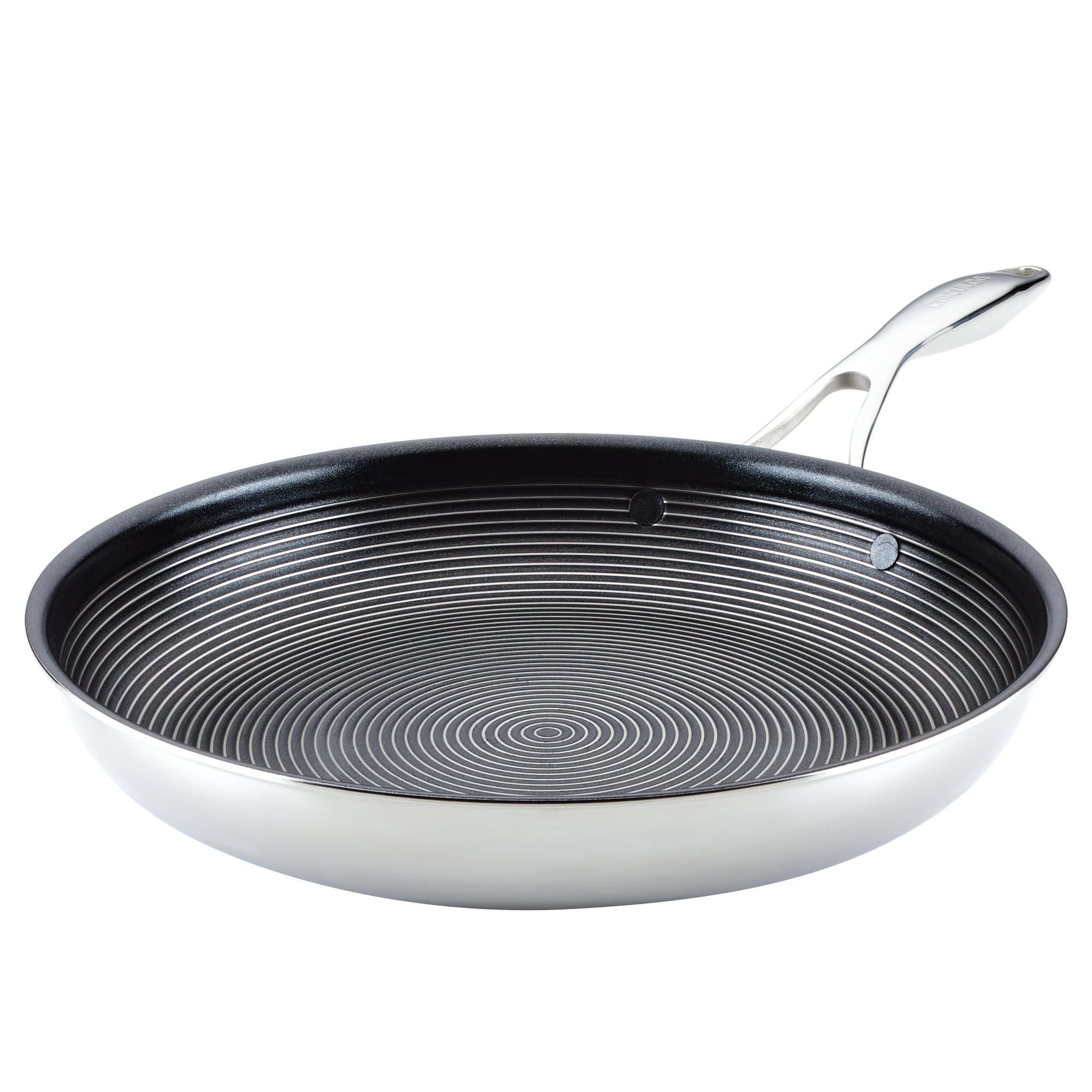 A stainless steel frying pan with a non-stick, circular patterned interior.