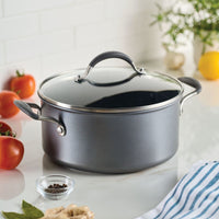 A 5-Quart ScratchDefense Dutch Oven with lid sits on the counter with tomatoes.
