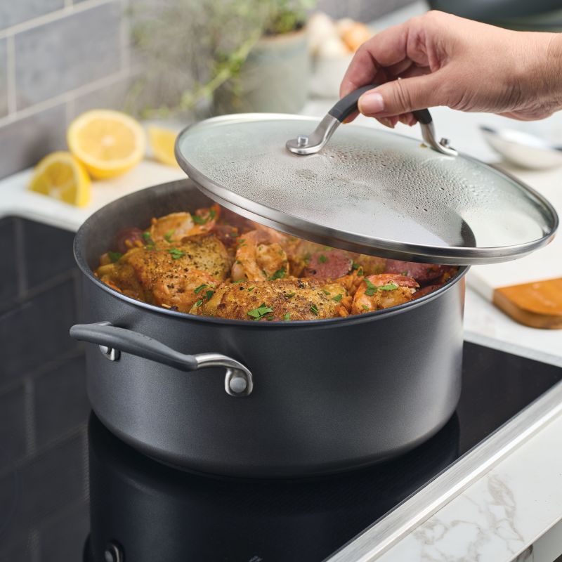 Lifting lid off 5-Quart ScratchDefense Nonstick Dutch Oven with chicken inside.
