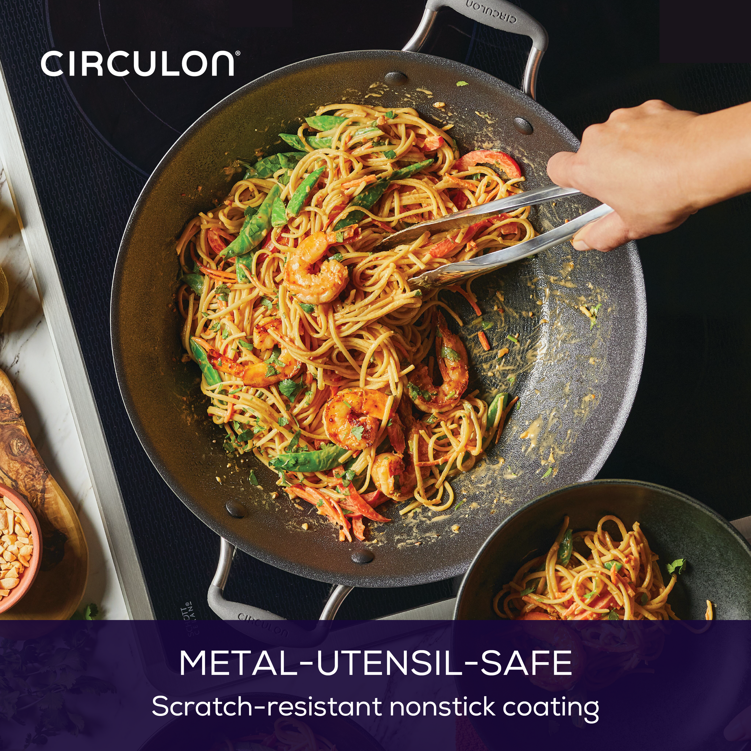 Person cooking shrimp pasta in a 14-Inch A1 ScratchDefense™ Nonstick Wok.
