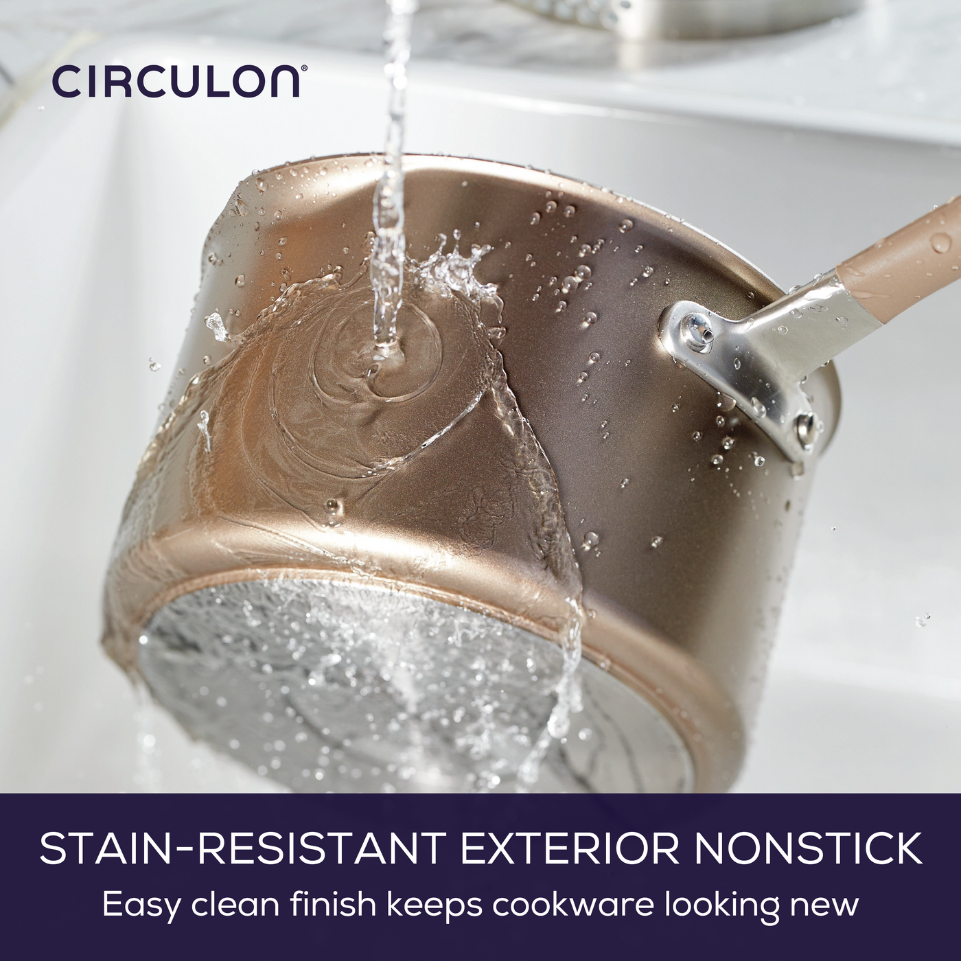 Water flows over a hard-anodized nonstick pot from the 8-Piece Nonstick Cookware Set in the sink, highlighting the set's durability and easy maintenance.