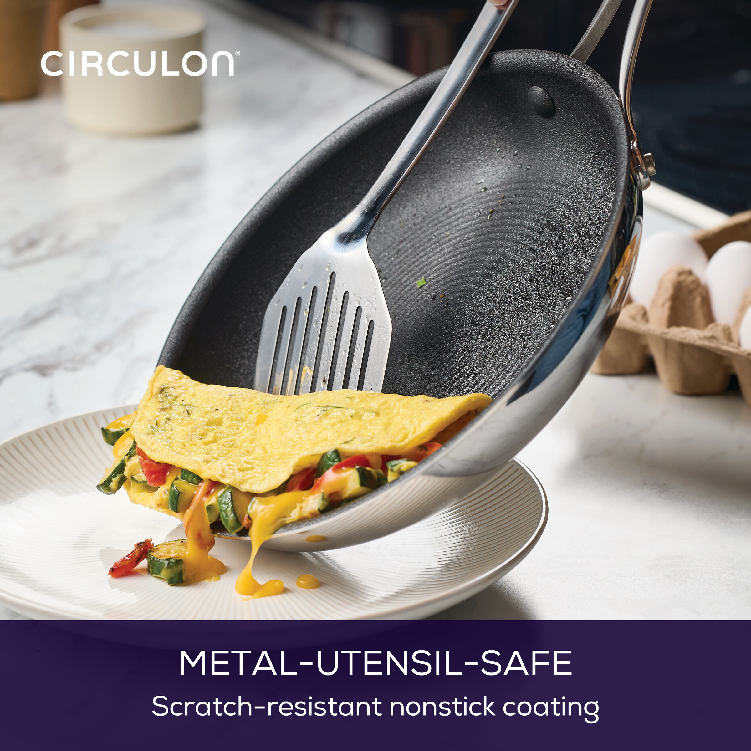 Cooking an omelette in a nonstick frying pan with a metal spatula.