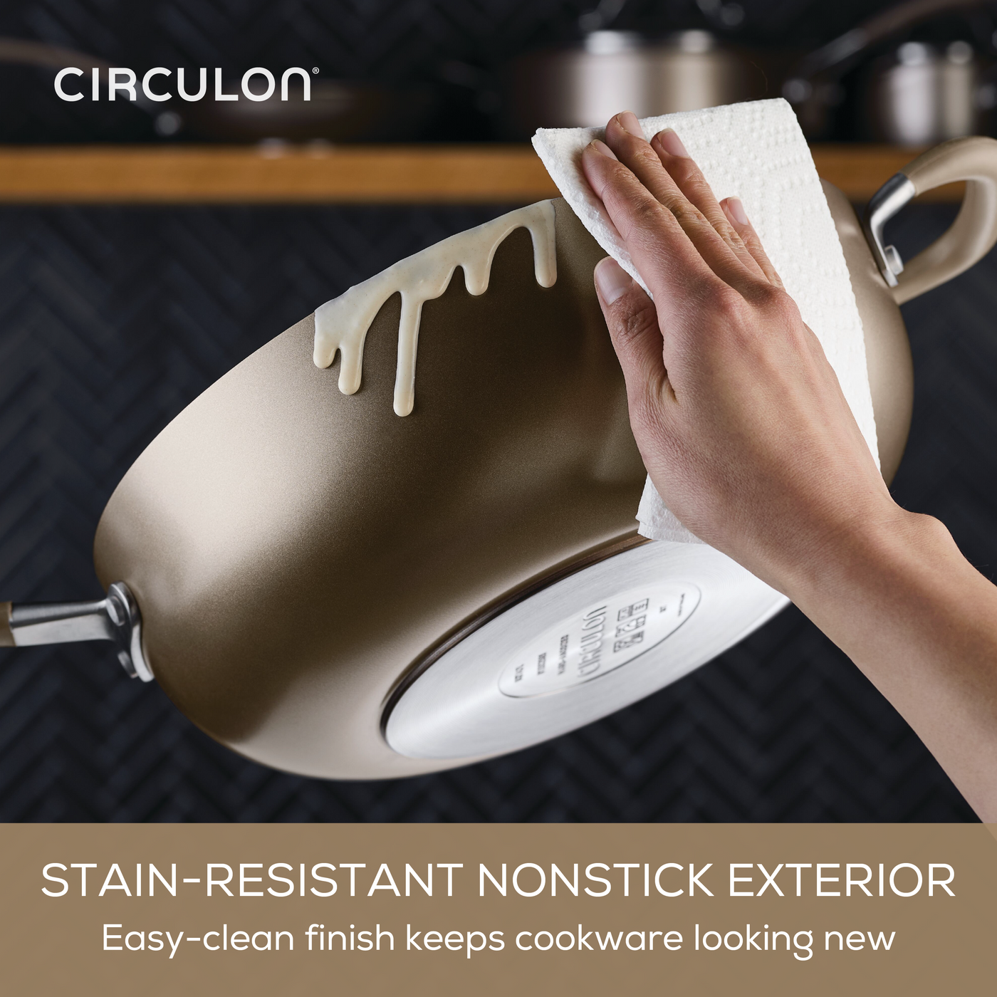 Using a paper towel to clean a 13-Piece ScratchDefense Nonstick Set pot.