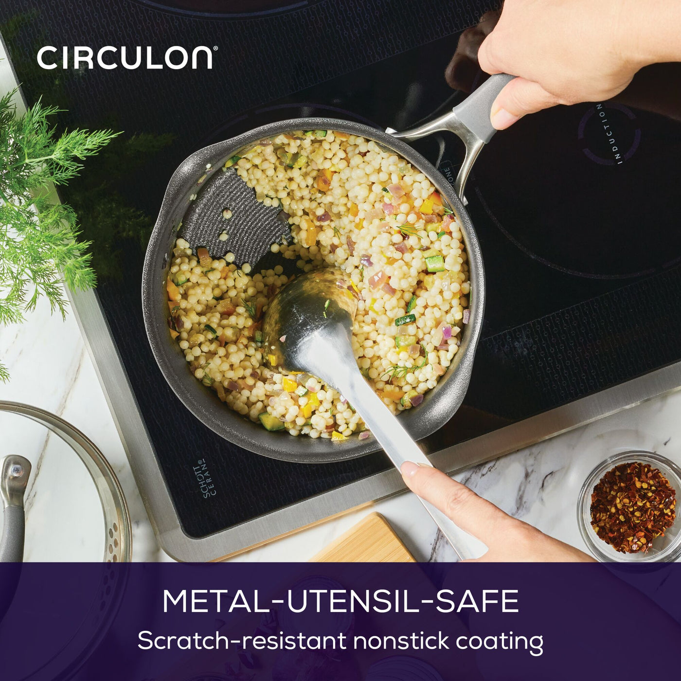 Person stirring pasta in a 3-Quart A1 ScratchDefense™ Nonstick Saucepan.