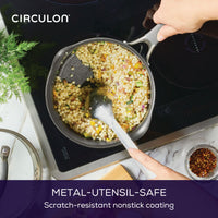 Person stirring pasta in a 3-Quart A1 ScratchDefense™ Nonstick Saucepan.