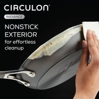 A person gently wipes food off a pan from the 3-Piece Nonstick Frying Pan Set with a cloth, ensuring its surface remains spotless.