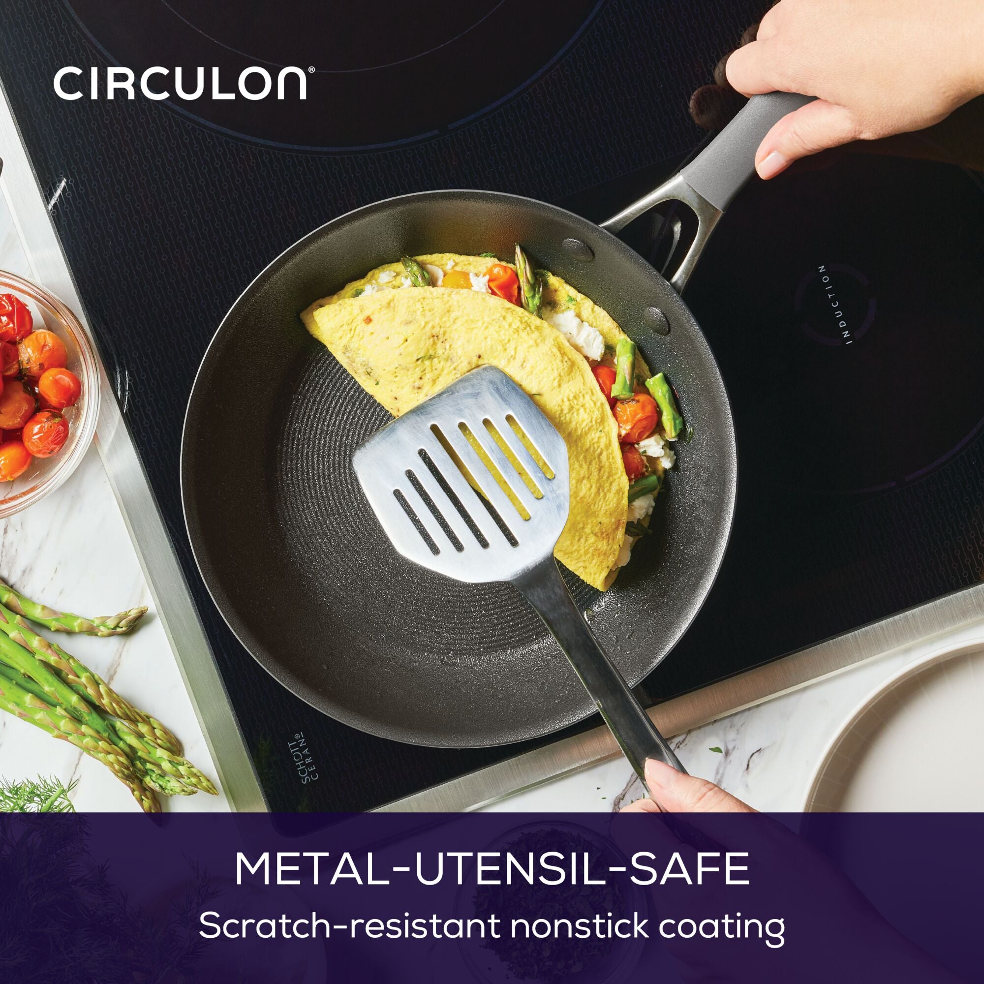 Person cooking an omelette in a nonstick pan with a spatula on a stovetop.