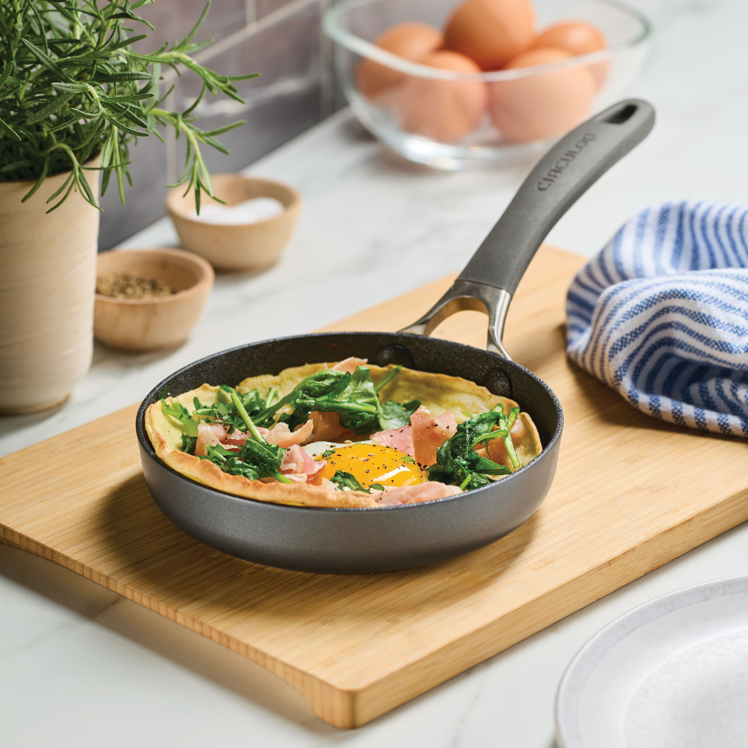 Omelette with spinach and ham in a ScratchDefense 6.25-Inch skillet.
