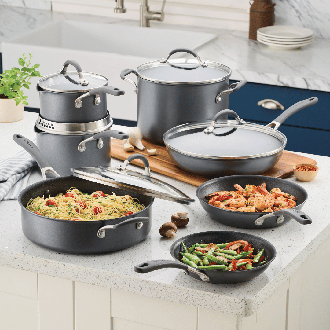 12-Piece ScratchDefense™ Nonstick Set with food on a kitchen counter.
