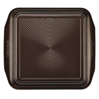 A 9-Inch Nonstick Square Cake Pan, expertly crafted from durable steel construction, features ridged details and a nonstick coating for easy release.