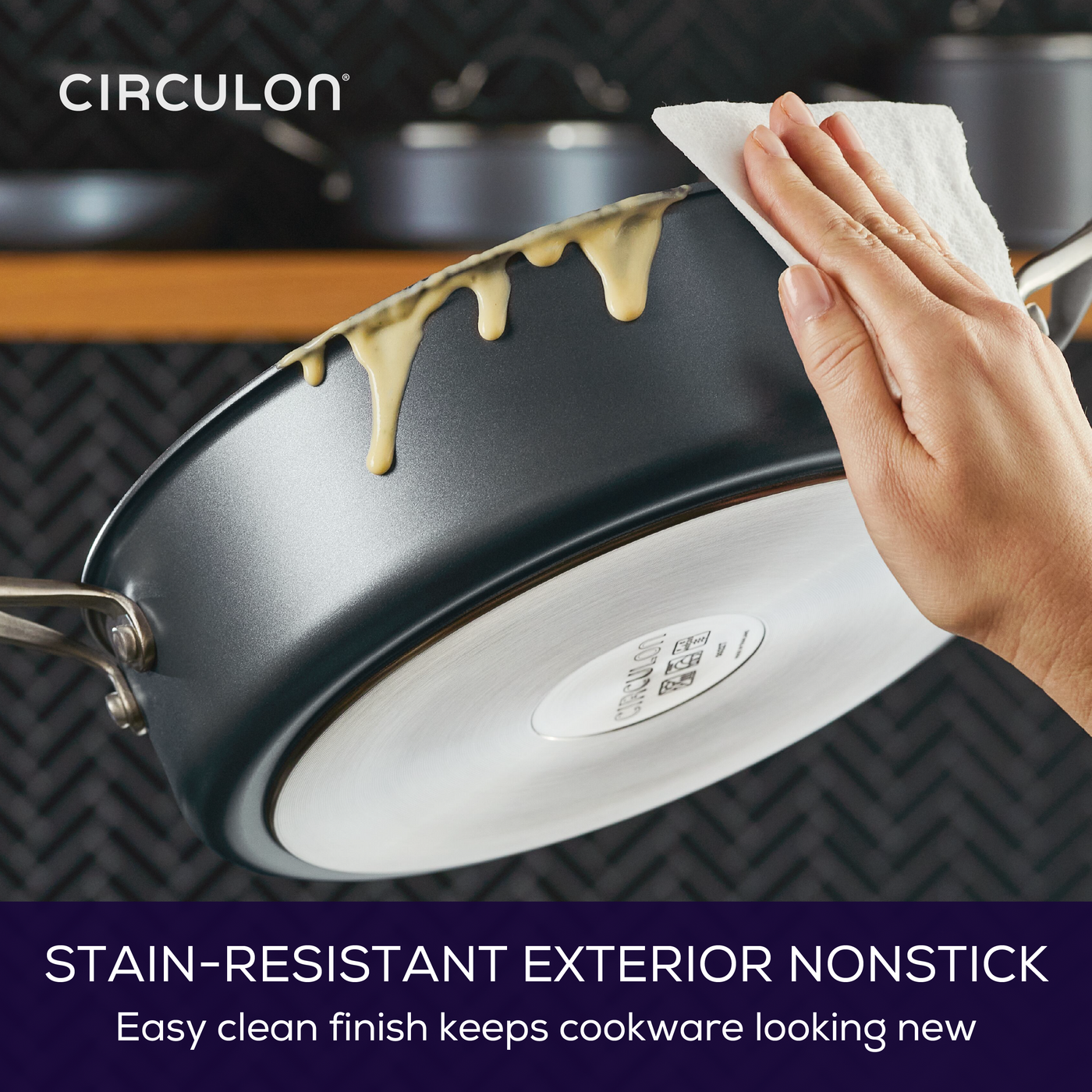 Wiping liquid off a 5-Quart A1 ScratchDefense™ Nonstick Saute Pan with Lid.
