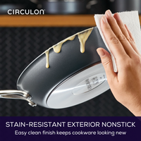 Hand wiping food off a 10-Inch ScratchDefense™ Fry Pan with a paper towel.