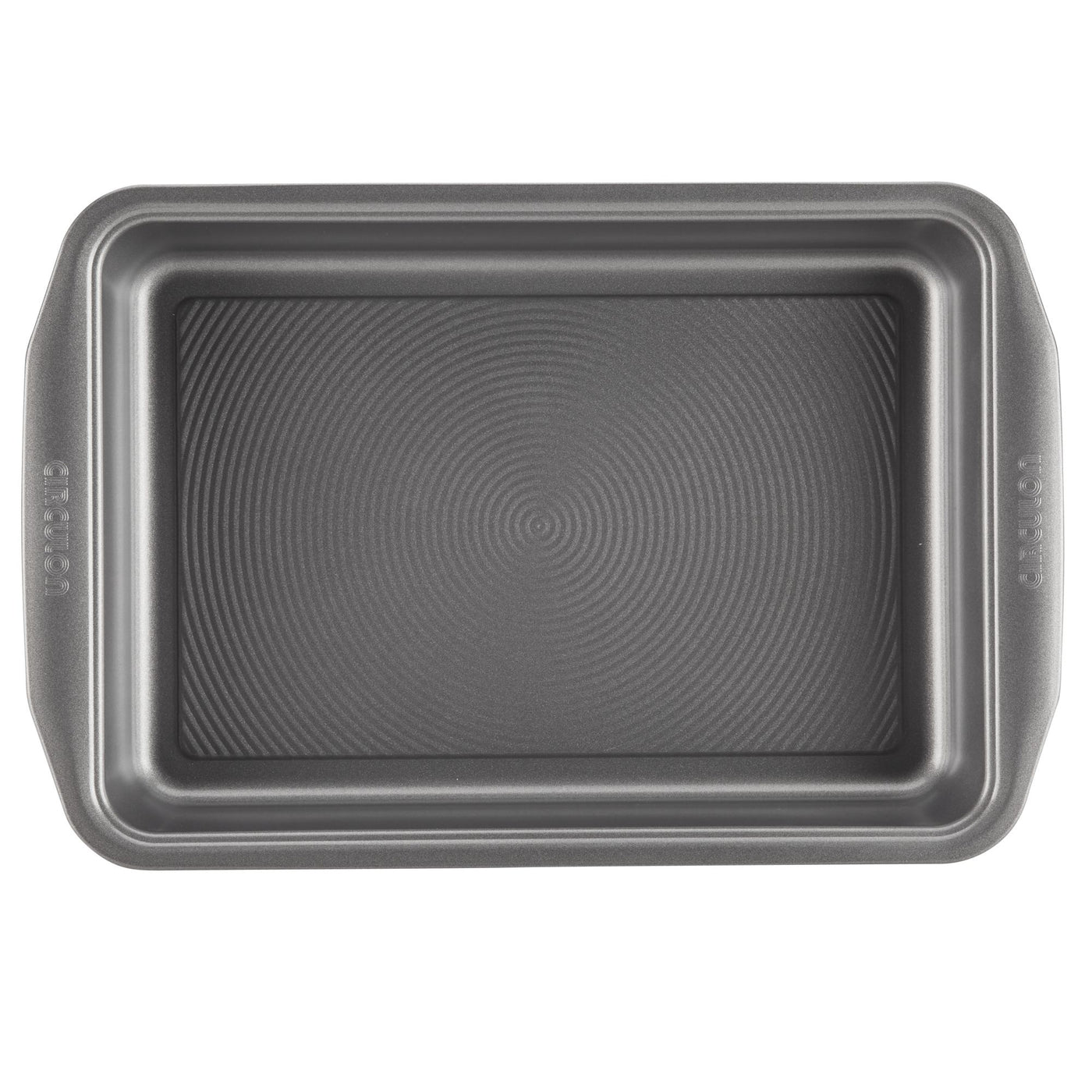 A rectangular pan from the 10-Piece Nonstick Bakeware Set, featuring a textured bottom and constructed from heavy gauge steel for enhanced warp resistance, seen from an overhead perspective.