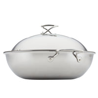 Wok equipped with Hybrid SteelShield Technology, a glass lid, and sturdy side handles.
