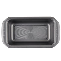 A rectangular bread pan from the 10-Piece Nonstick Bakeware Set includes handles, is constructed from heavy gauge steel to resist warping, and has a nonstick finish.