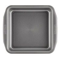 A square baking pan from the 10-Piece Nonstick Bakeware Set, featuring two handles and a textured interior, crafted from heavy gauge steel to resist warping.