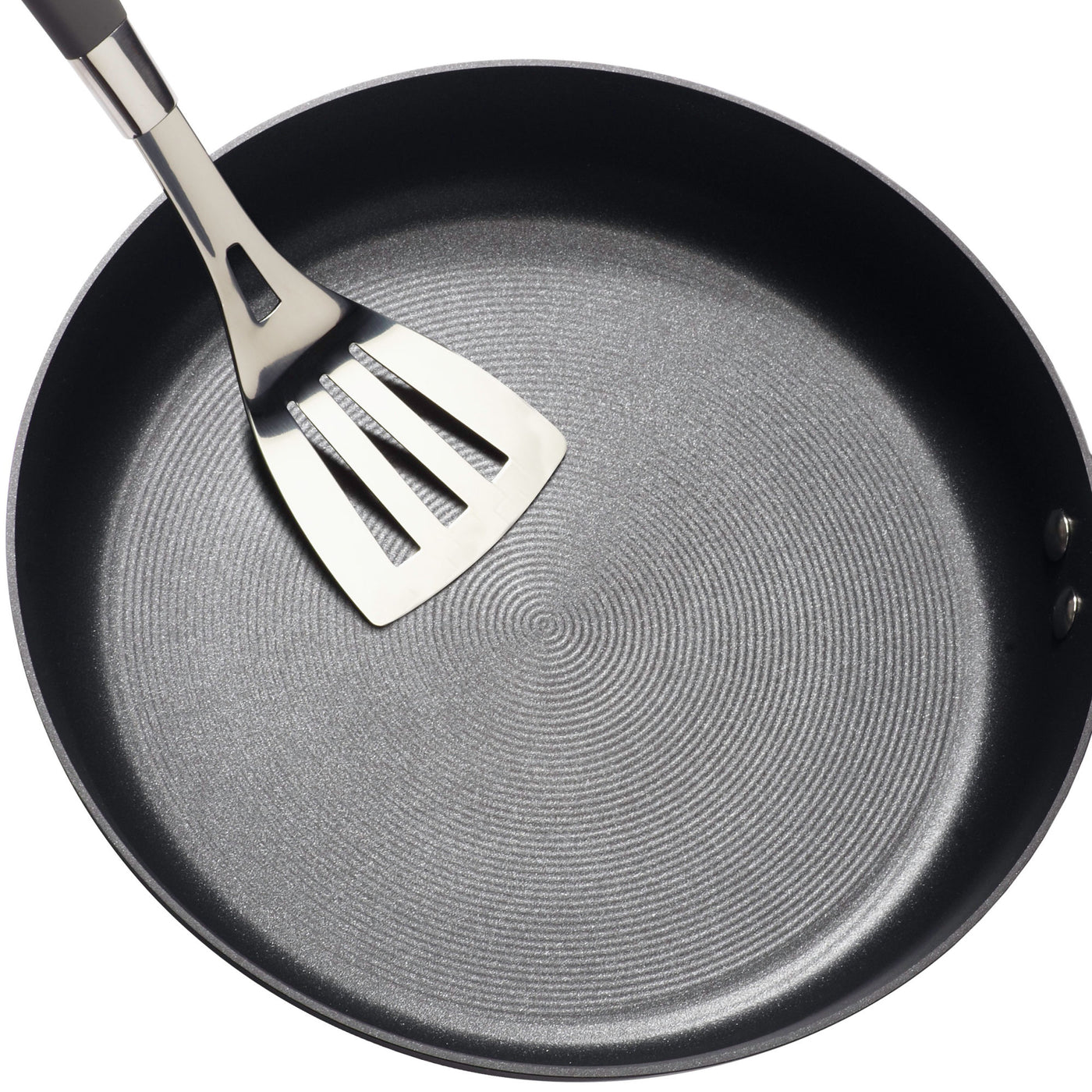 8.5-Inch Nonstick Frying Pan featuring a hard-anodized finish, designed for use on induction stovetops, complete with a metal spatula resting inside.