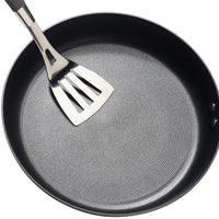Hard-Anodized Frying Pan Set accompanied by a metal spatula on a white background, showcasing an advanced nonstick system for effortless cooking and cleanup.