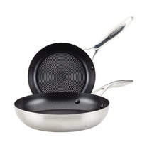 A set of 8" and 10.25" hybrid stainless steel frying pans with nonstick textured interiors, suitable for induction cooking.